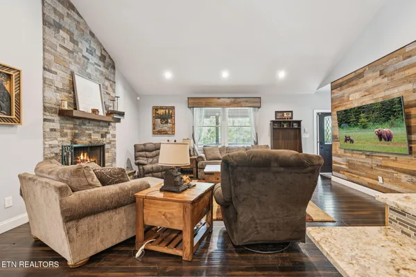 a living room with fireplace furniture and a fireplace