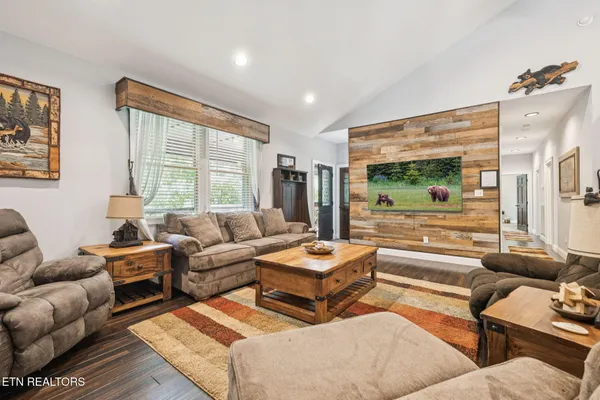 a kitchen with stainless steel appliances granite countertop a stove refrigerator and a wooden cabinets