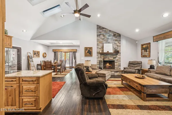 a kitchen with stainless steel appliances granite countertop a kitchen island a stove and a sink