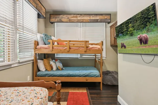 a bedroom with a bed dresser and a window