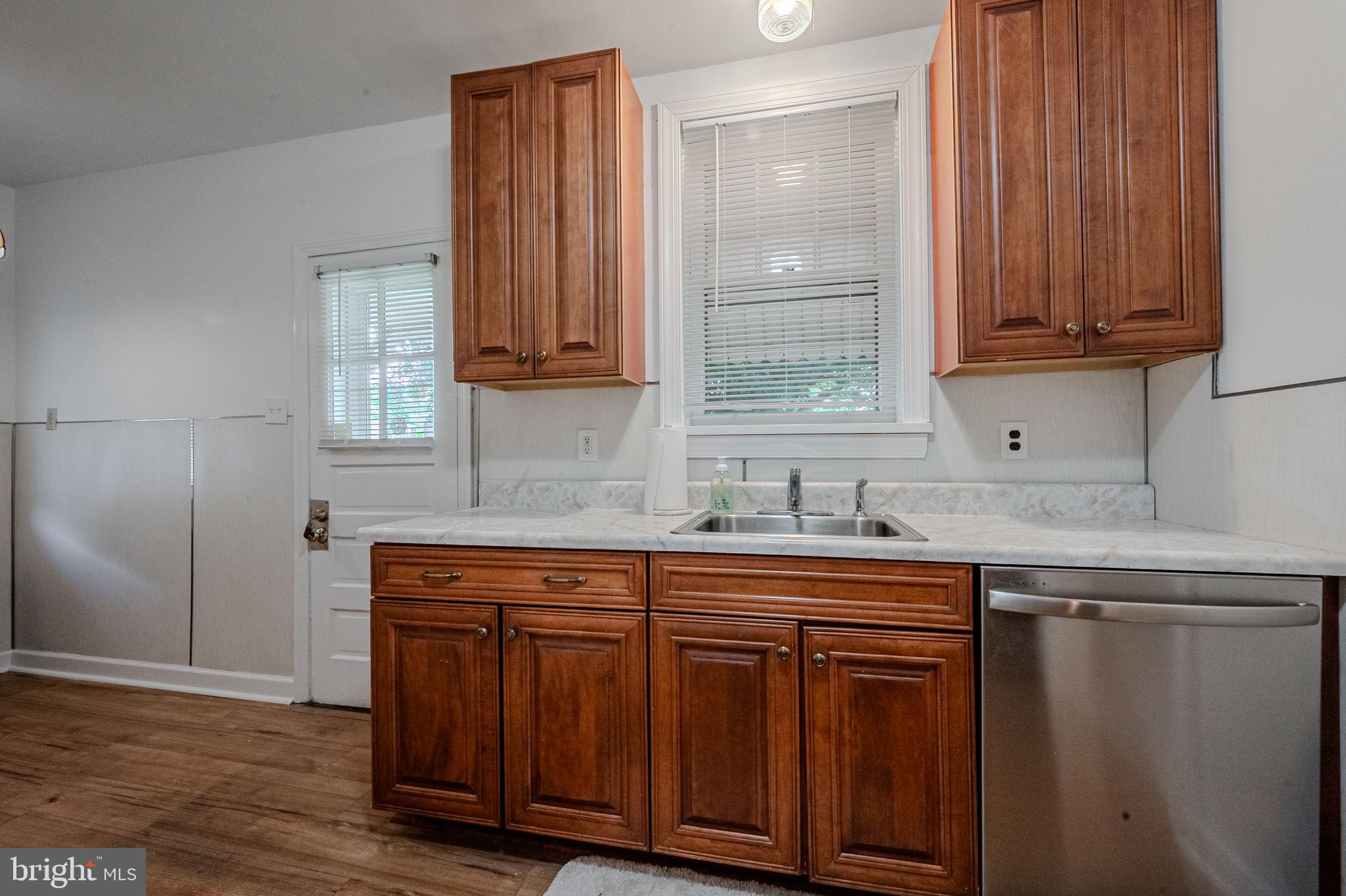 624 Gilbert Road Ridley Park, PA 19078 - Photo 11 of 36 a kitchen with stainless steel appliances granite countertop wooden cabinets a sink and dishwasher with wooden floor