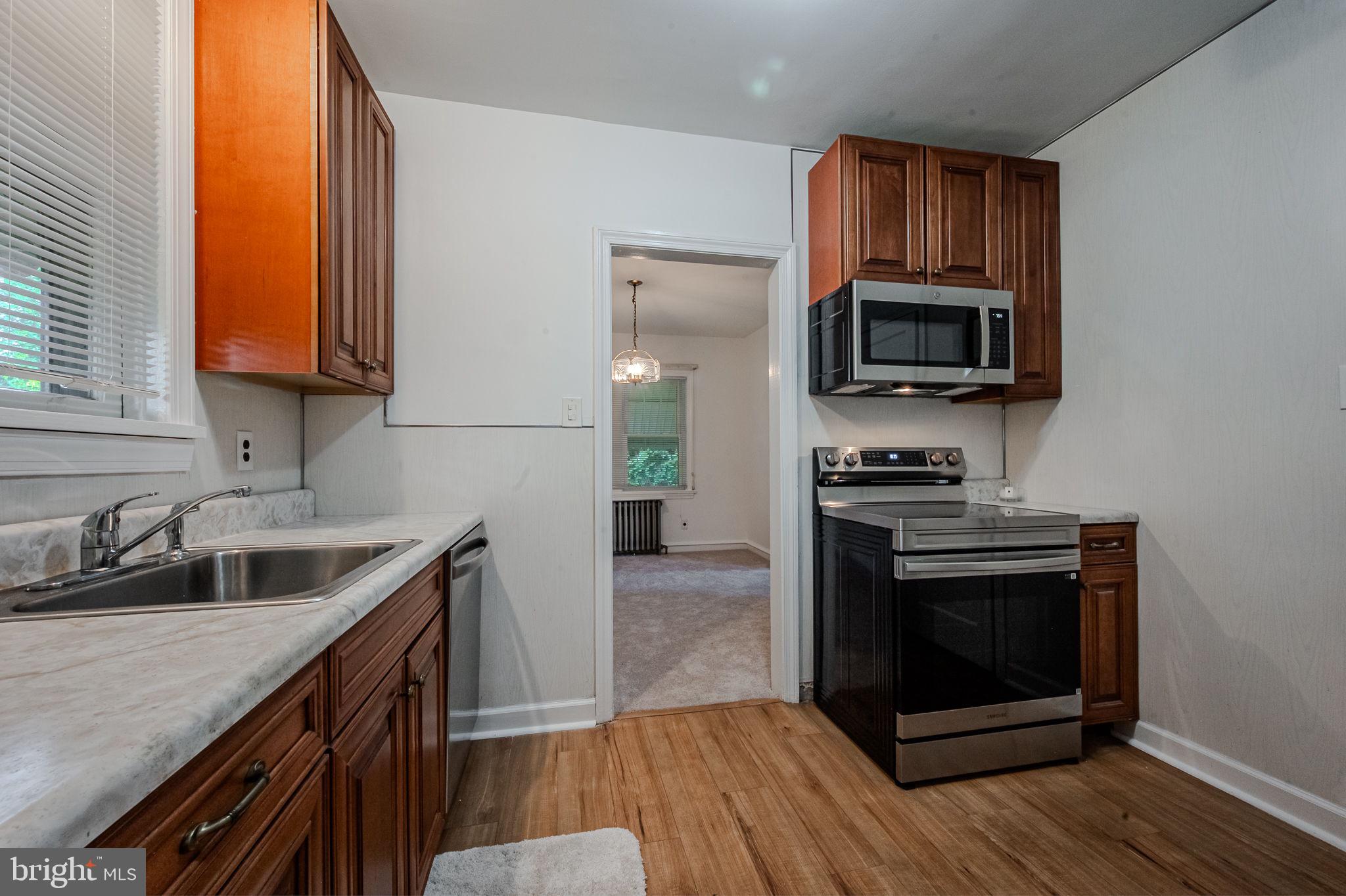 624 Gilbert Road Ridley Park, PA 19078 - Photo 12 of 36 a kitchen with sink a microwave a stove and cabinets