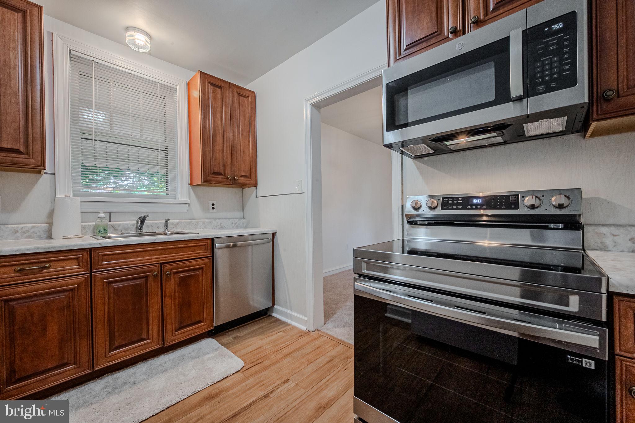 624 Gilbert Road Ridley Park, PA 19078 - Photo 14 of 36 a kitchen with stainless steel appliances a stove microwave and sink