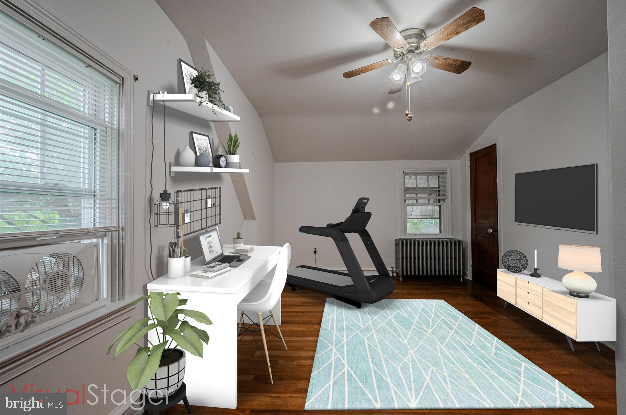 624 Gilbert Road Ridley Park, PA 19078 - Photo 16 of 36 a living room with furniture a flat screen tv and a floor to ceiling window