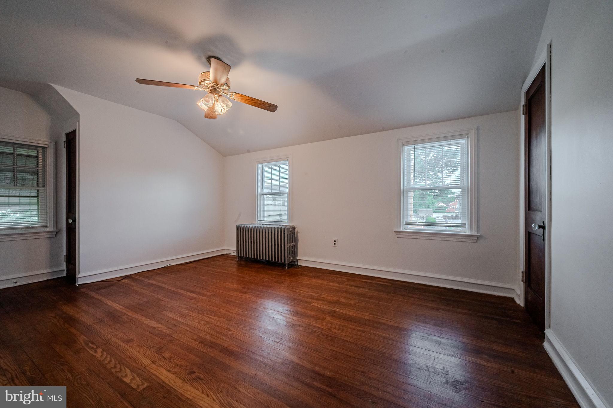 624 Gilbert Road Ridley Park, PA 19078 - Photo 24 of 36 an empty room with wooden floor chandelier fan and windows