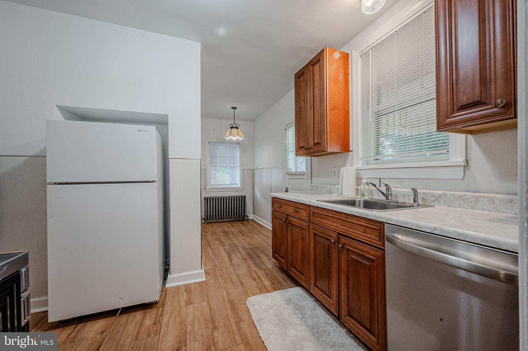 624 Gilbert Road Ridley Park, PA 19078 - Photo 10 of 36 a kitchen with stainless steel appliances granite countertop a refrigerator a sink dishwasher a stove with wooden floor