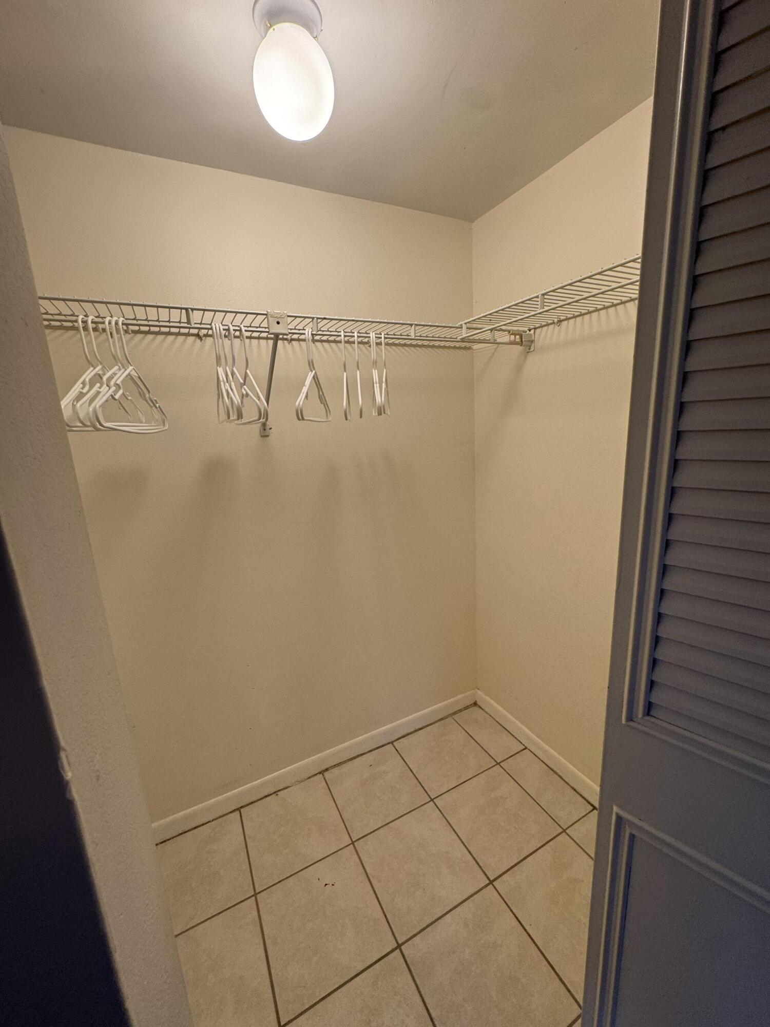 21890 Lake Forest Circle, Unit 102 Boca Raton, FL 33433 - Photo 12 of 24 a view of a room with racks on the wall