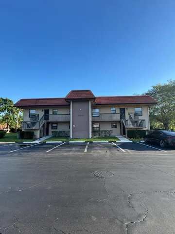 front view of a brick house with a yard