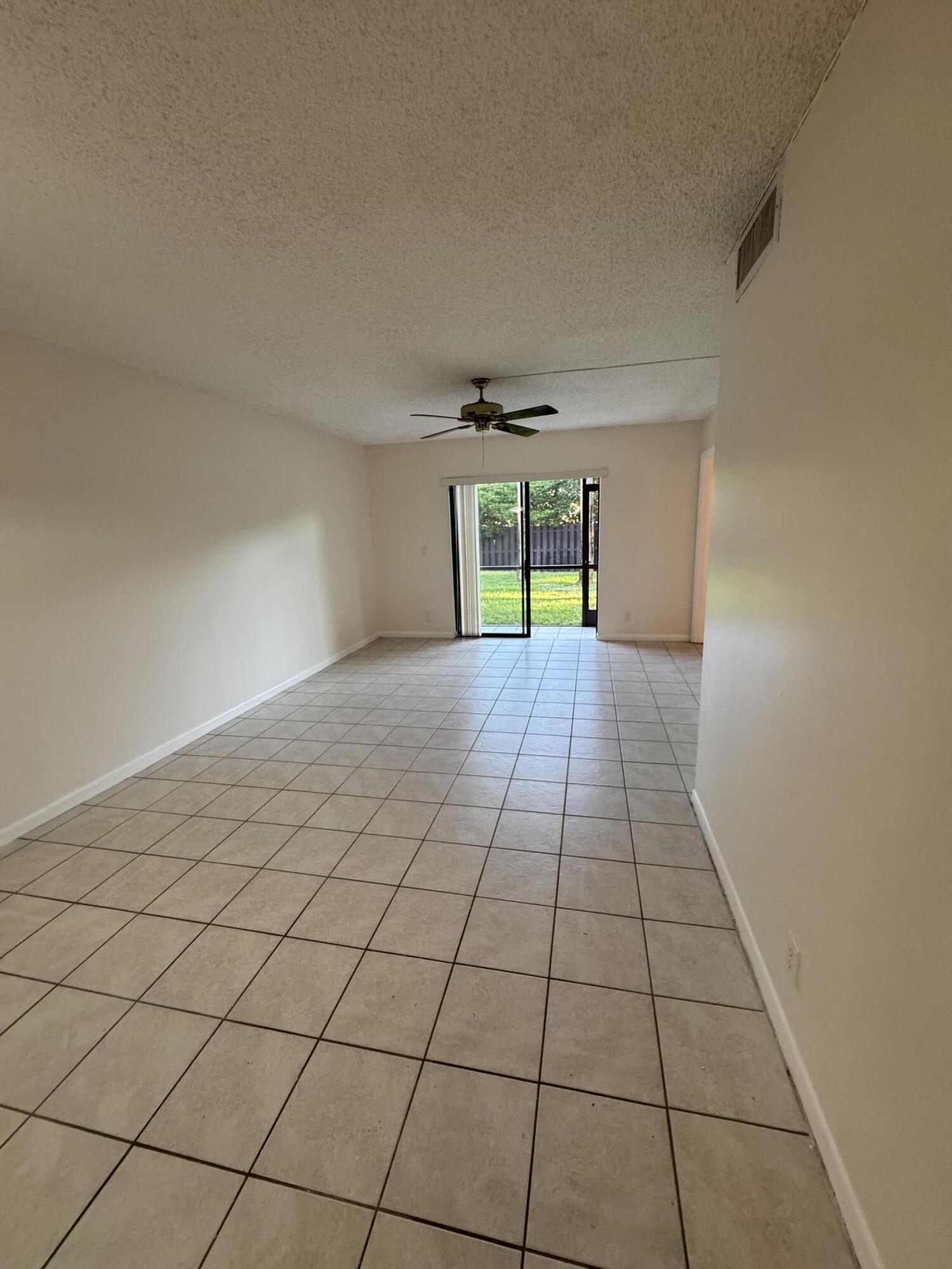 21890 Lake Forest Circle, Unit 102 Boca Raton, FL 33433 - Photo 6 of 24 a view of an empty room and window