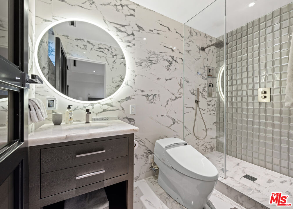 145 Channel Pointe Mall Marina del Rey, CA 90292 - Photo 42 of 75 a bathroom with a granite countertop toilet sink and mirror