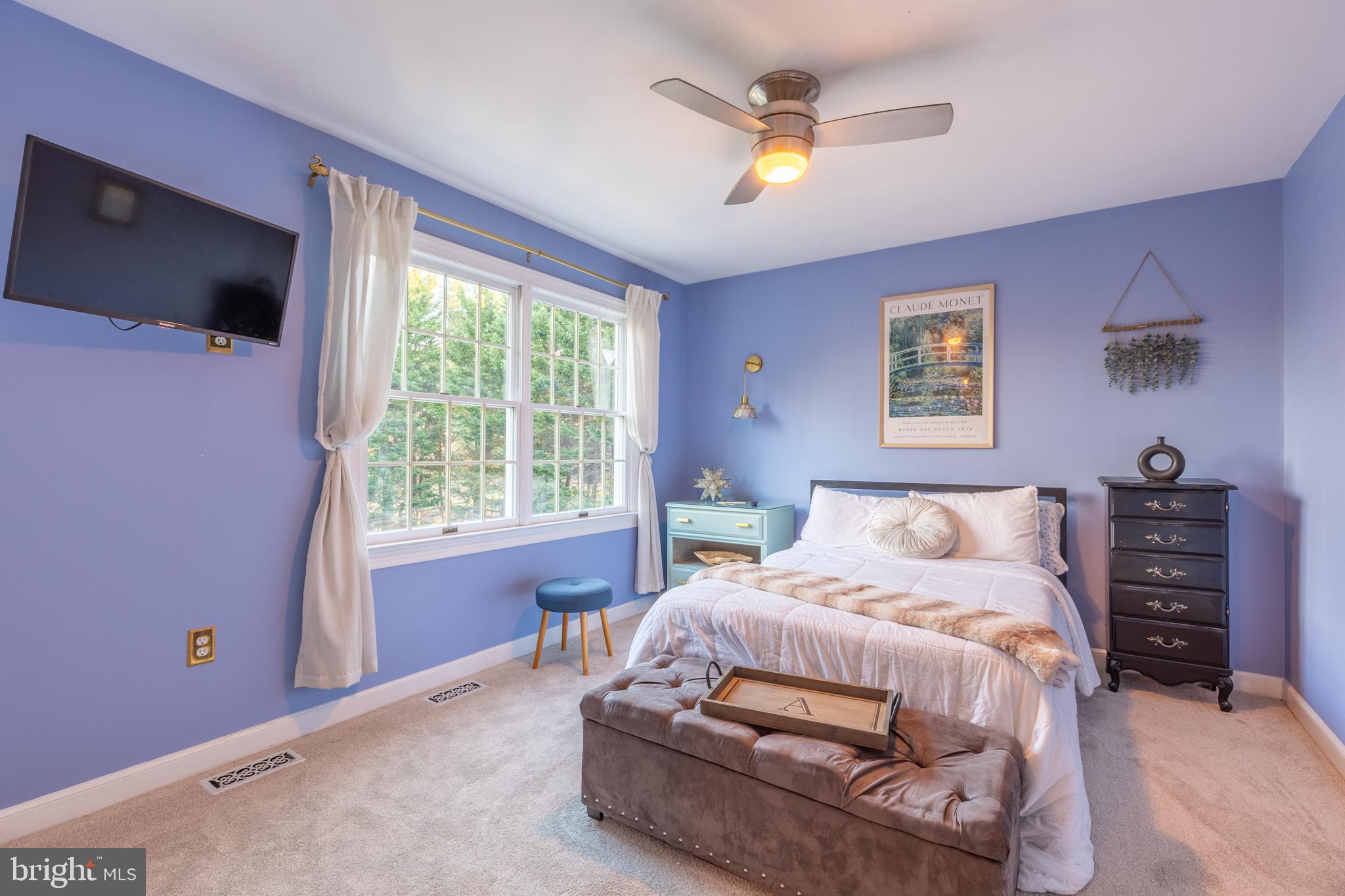 3 Heatherstone Way Hockessin, DE 19707 - Photo 16 of 29 a bedroom with a bed and a flat tv screen on dresser