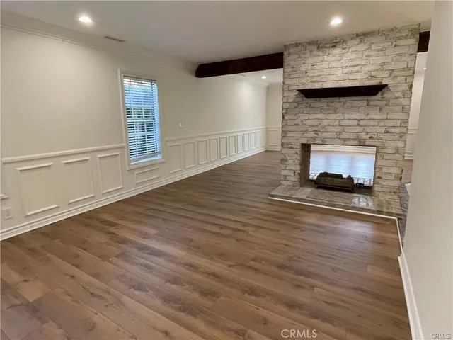 a living room with a fireplace and a wooden floor