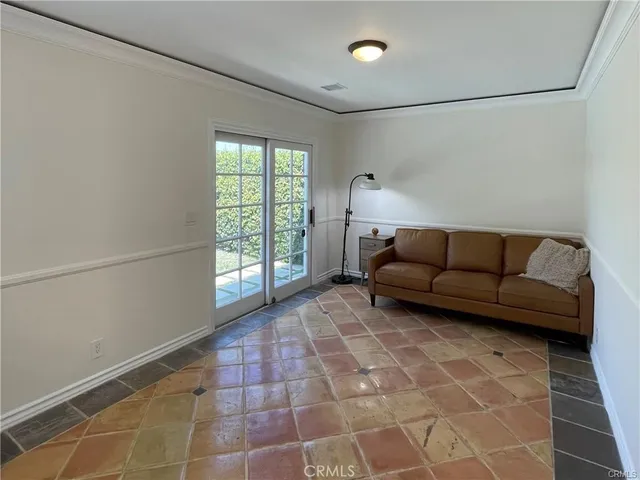 a living room with a couch and a glass window