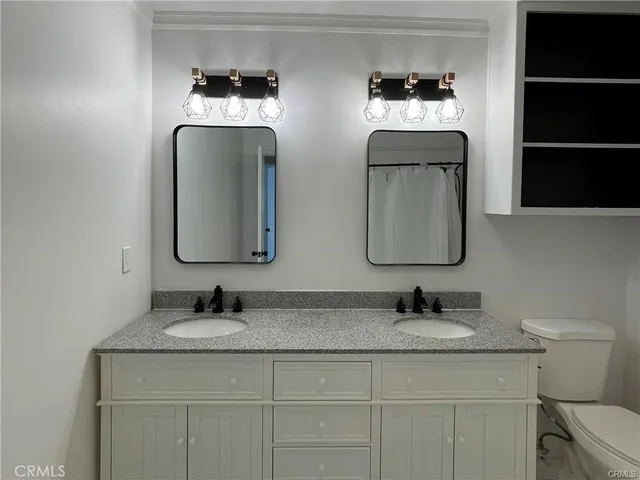 a bathroom with 2 sink and a mirror