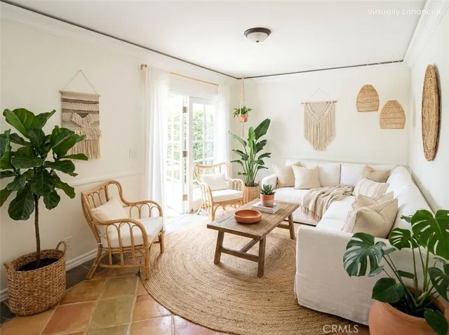a living room with furniture and a potted plant