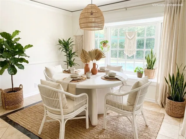 a dining room with furniture potted plants and wooden floor