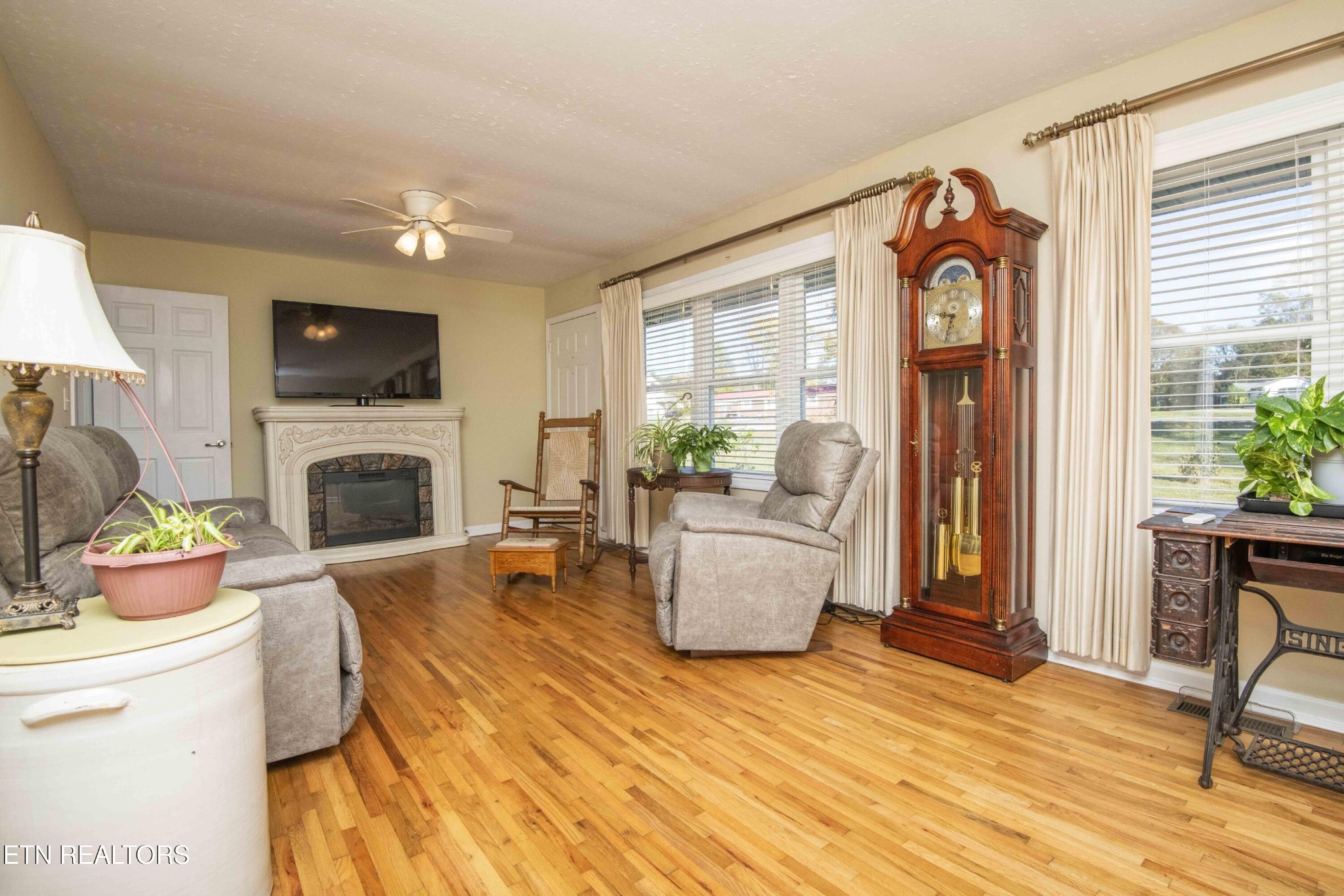651 Hines Valley Road Lenoir City, TN 37771 - Photo 13 of 44 a living room with furniture a fireplace and a flat screen tv