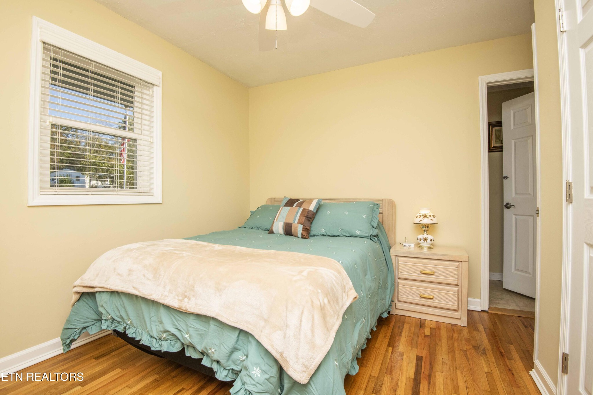 651 Hines Valley Road Lenoir City, TN 37771 - Photo 16 of 44 a bedroom with a bed and a wooden floor