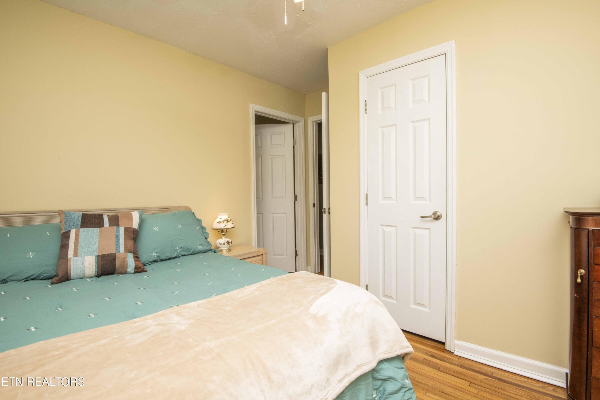 651 Hines Valley Road Lenoir City, TN 37771 - Photo 18 of 44 a bedroom with a bed and wooden floor