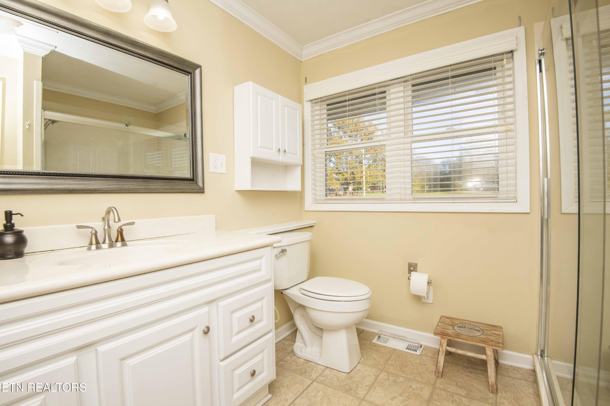 651 Hines Valley Road Lenoir City, TN 37771 - Photo 20 of 44 a bathroom with a granite countertop sink mirror vanity and toilet