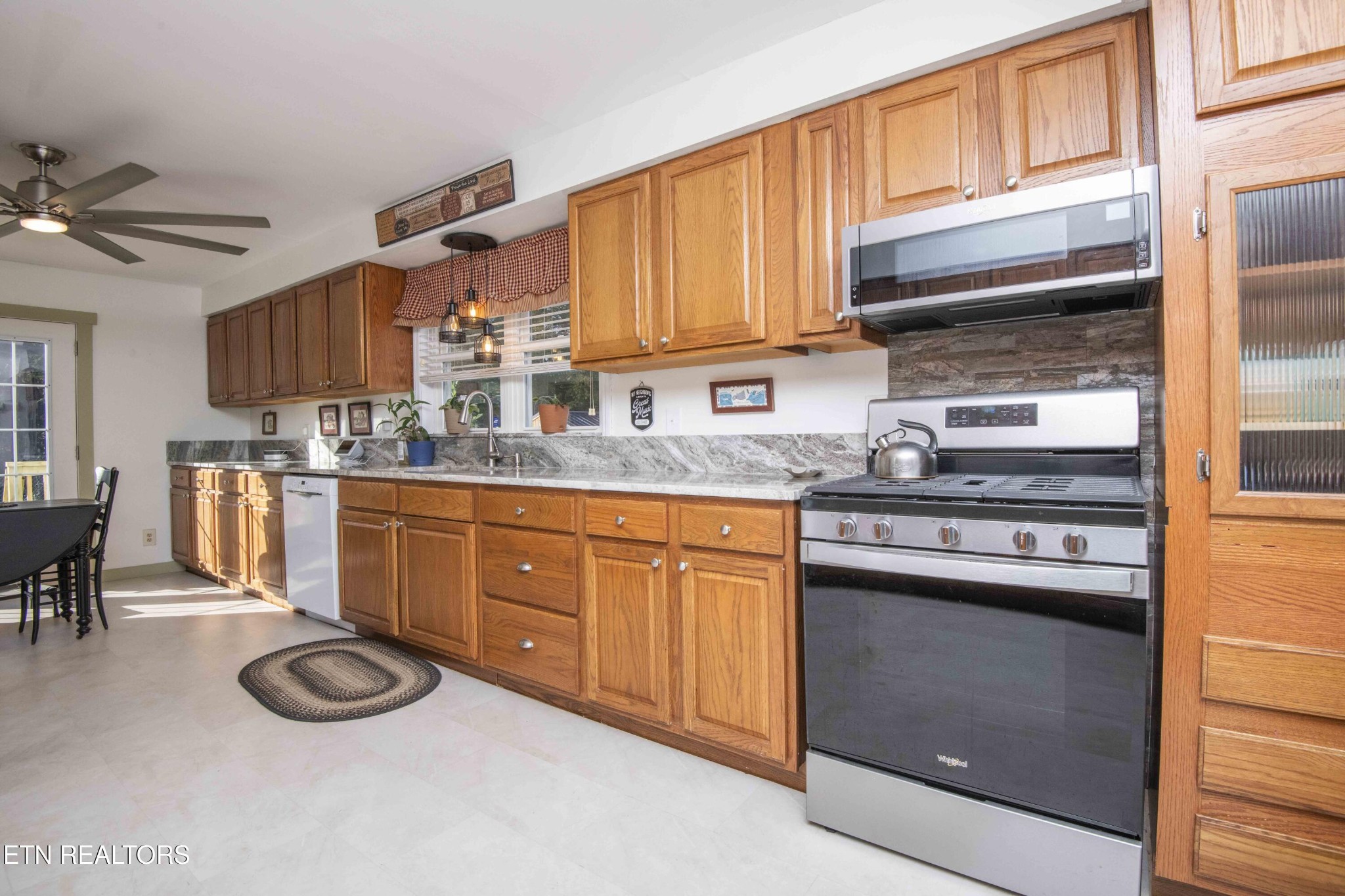 651 Hines Valley Road Lenoir City, TN 37771 - Photo 2 of 44 a kitchen with stainless steel appliances granite countertop a stove a sink and a microwave