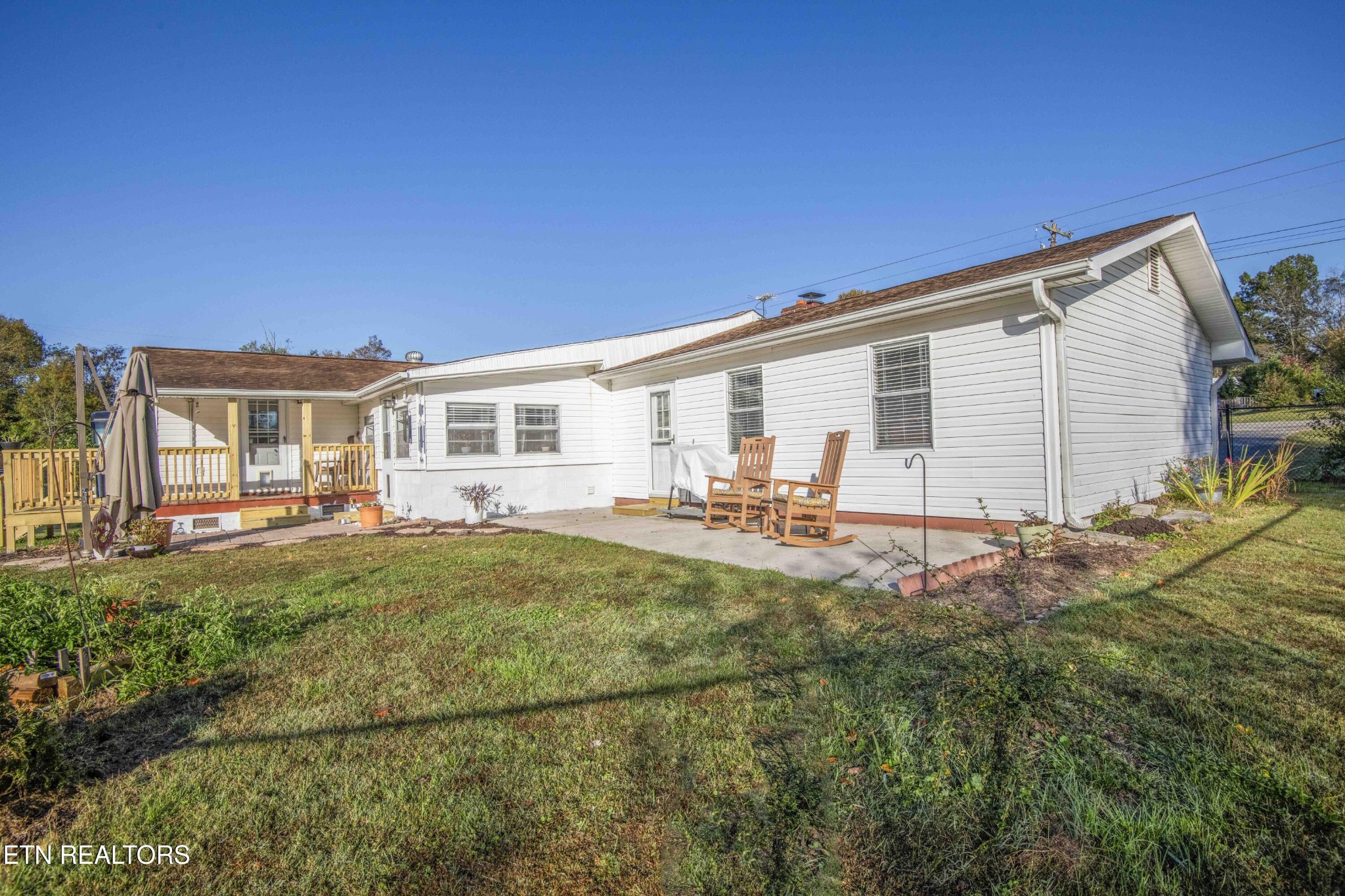 651 Hines Valley Road Lenoir City, TN 37771 - Photo 32 of 44 a backyard of a house with table and chairs
