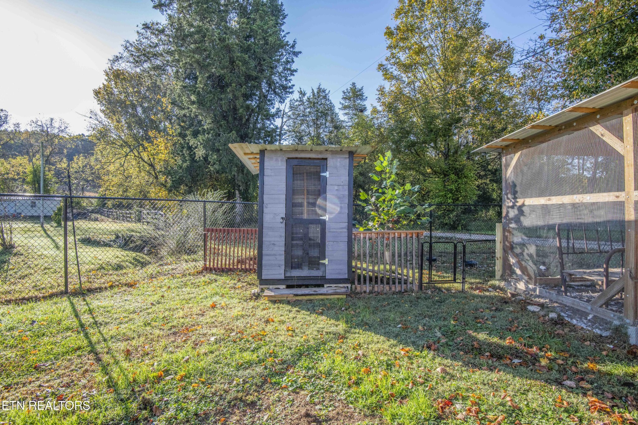 651 Hines Valley Road Lenoir City, TN 37771 - Photo 37 of 44 a view of backyard with wooden fence and a large tree