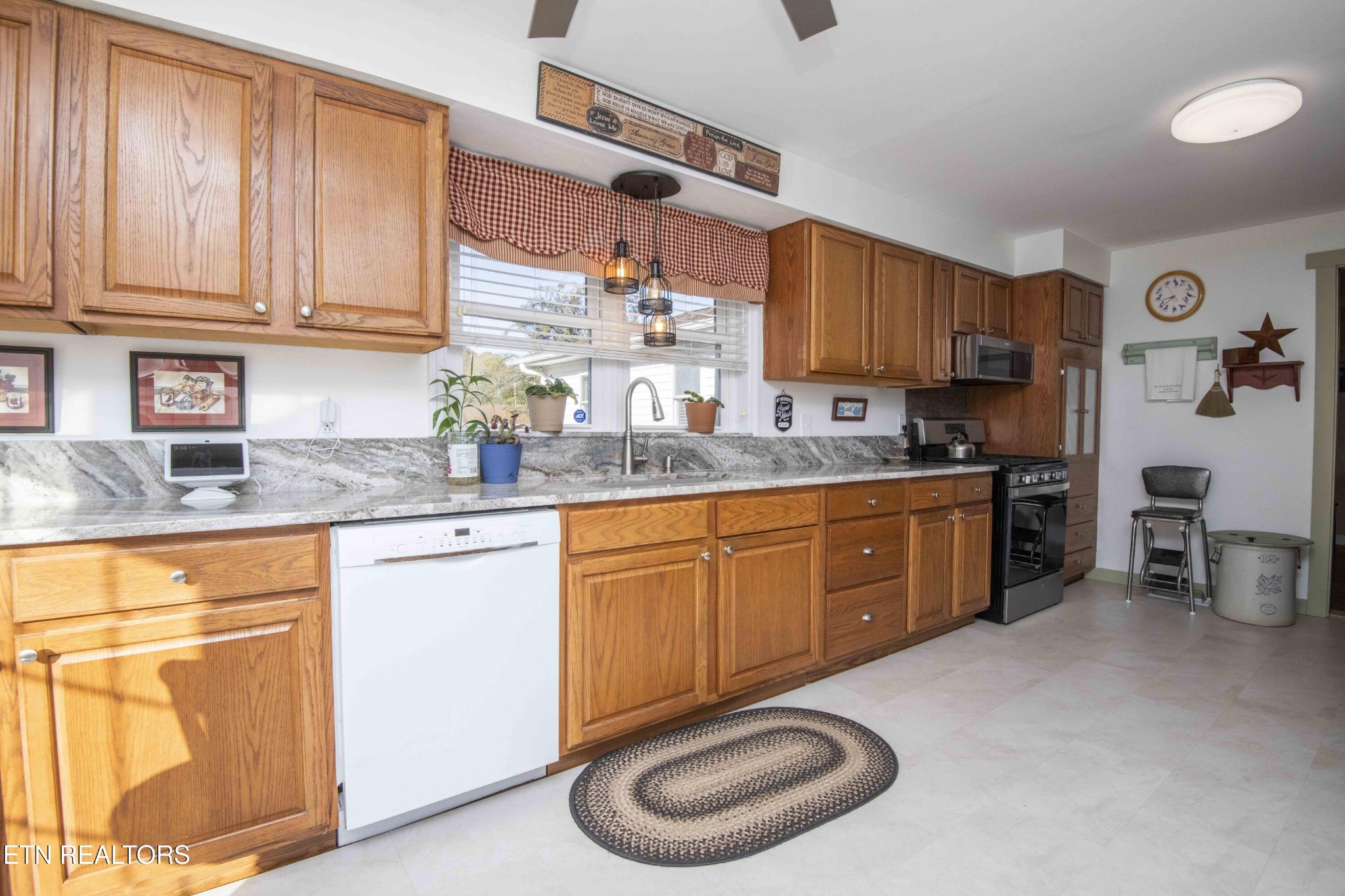 651 Hines Valley Road Lenoir City, TN 37771 - Photo 4 of 44 a kitchen with stainless steel appliances granite countertop a sink a stove and cabinets