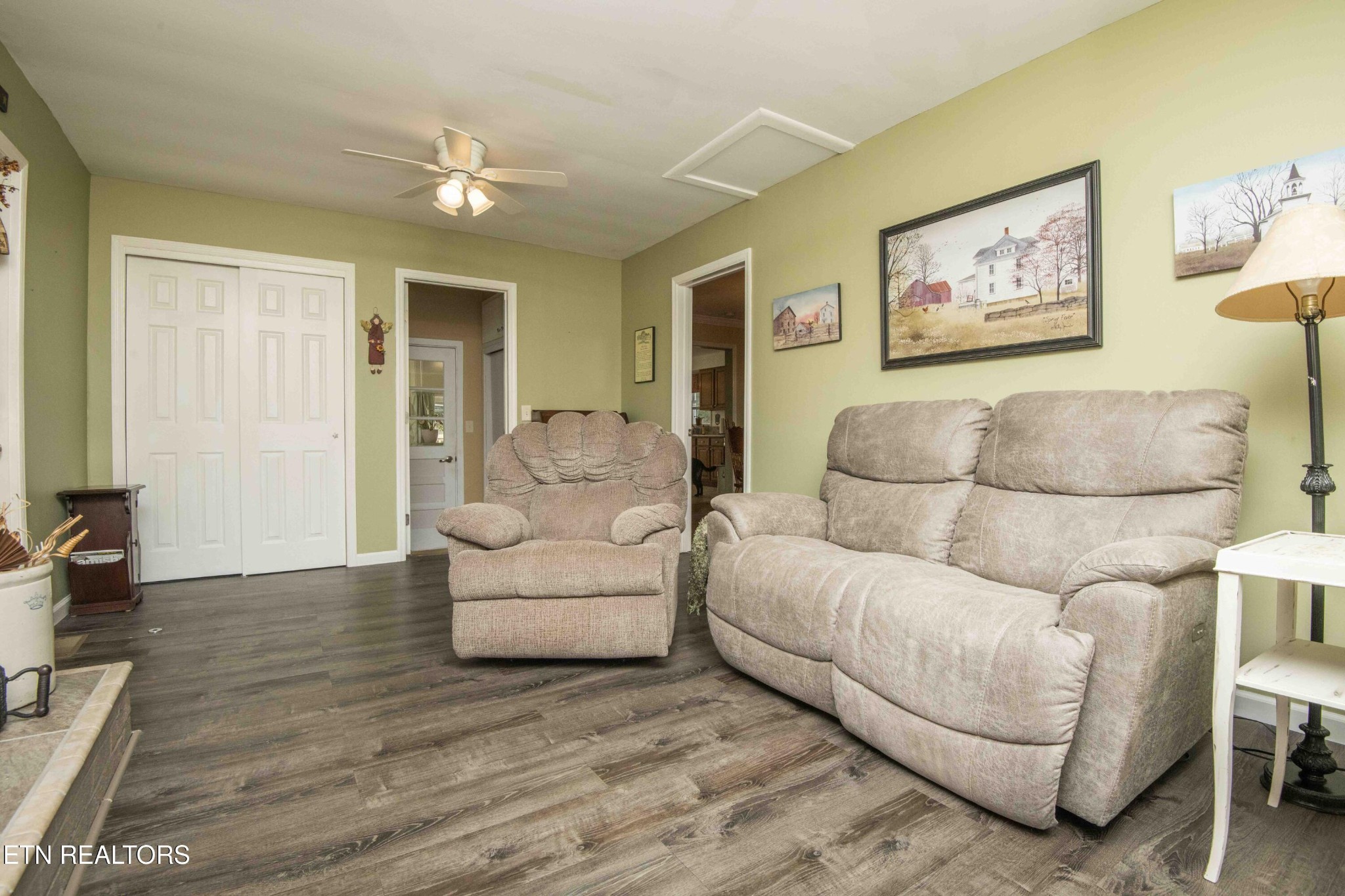 651 Hines Valley Road Lenoir City, TN 37771 - Photo 8 of 44 a living room with furniture and a large mirror with wooden floor