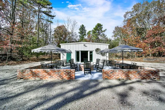 a view of a patio with a table and chairs under an umbrella