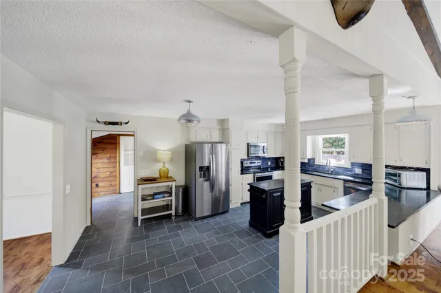 a view of living room kitchen and refrigerator