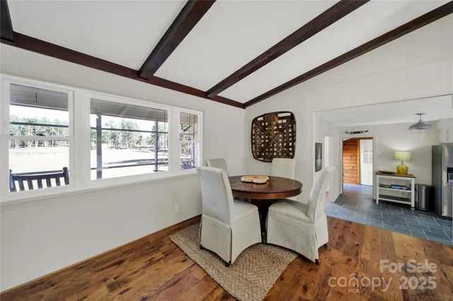 a view of a livingroom with furniture window and a wooden floor