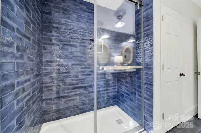 a bathroom with a bathtub and shower