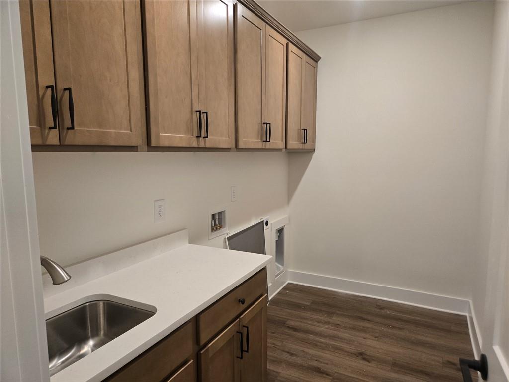 215 Coffee Lane Hoschton, GA 30548 - Photo 11 of 34 a utility room with wooden floor and cabinets