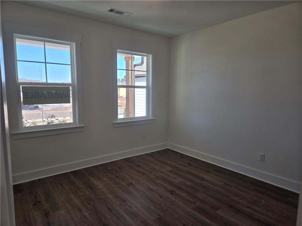 215 Coffee Lane Hoschton, GA 30548 - Photo 12 of 34 a view of an empty room with wooden floor and a window