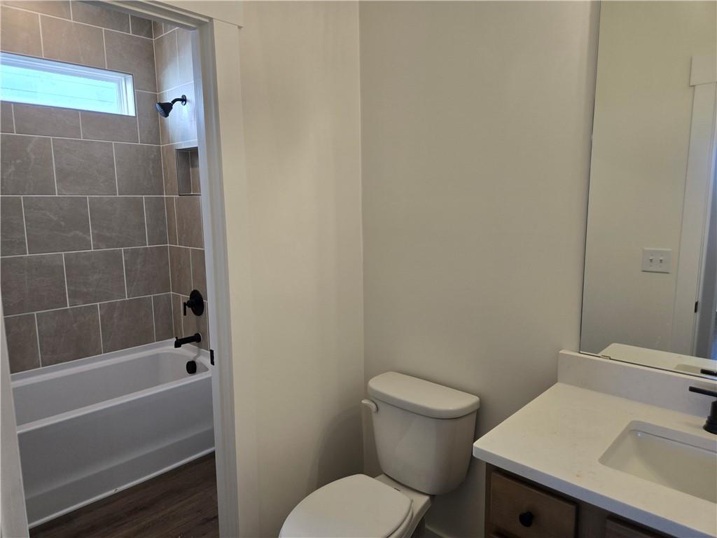 215 Coffee Lane Hoschton, GA 30548 - Photo 13 of 34 a bathroom with a sink a toilet and bathtub
