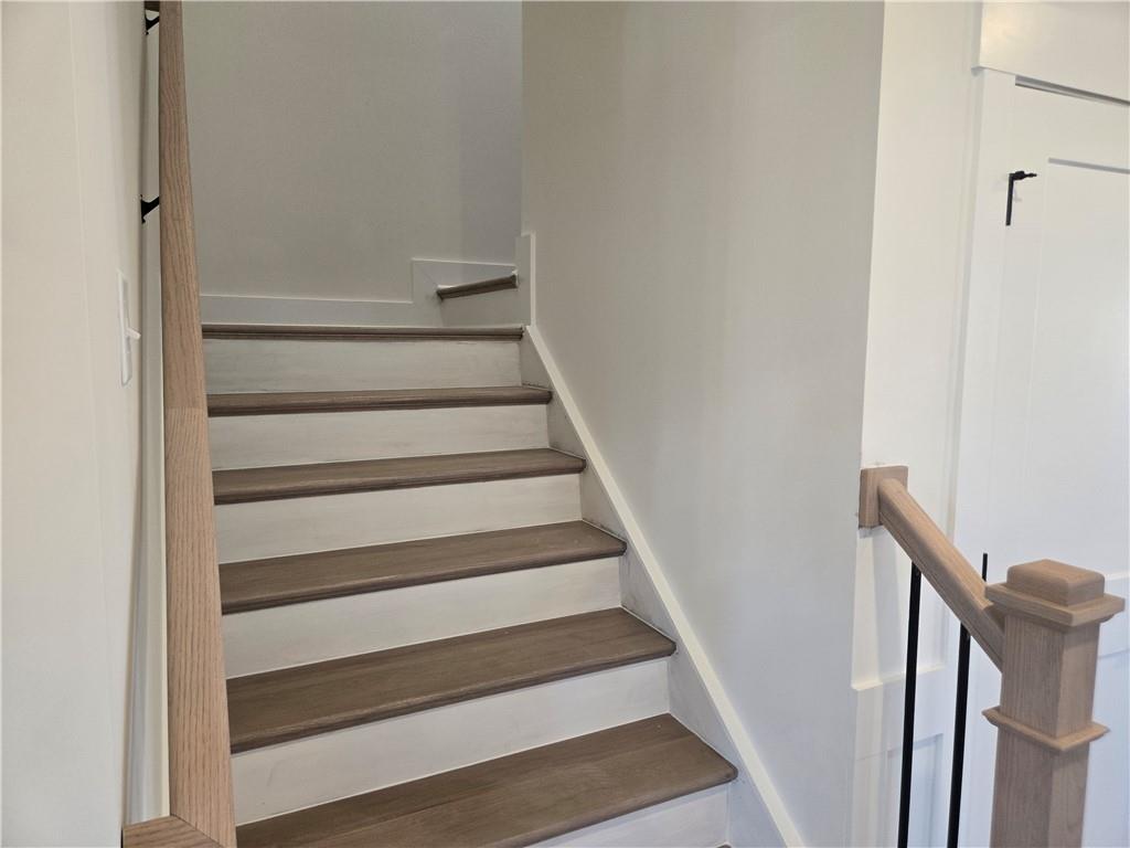 215 Coffee Lane Hoschton, GA 30548 - Photo 14 of 34 a view of staircase with white walls and a window