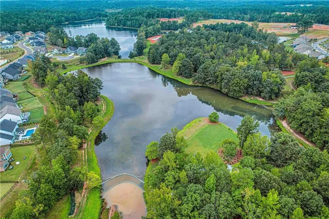 an aerial view of a house with a yard and lake view