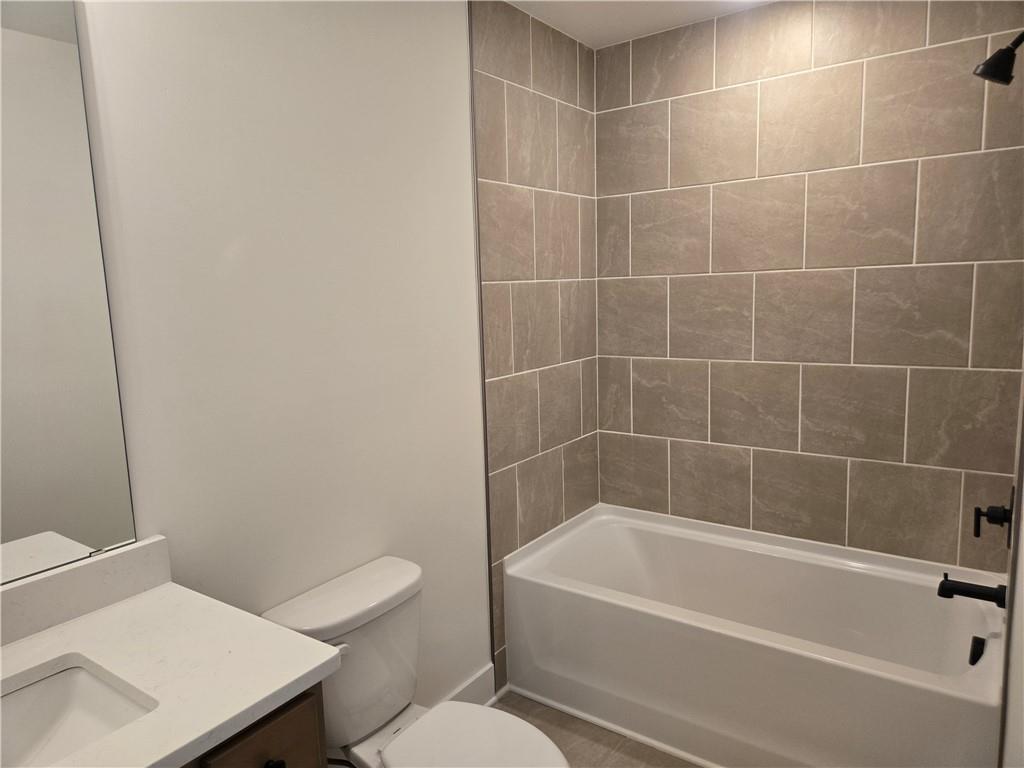 215 Coffee Lane Hoschton, GA 30548 - Photo 18 of 34 a white bath tub sitting next to a white toilet