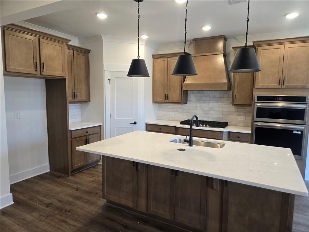 215 Coffee Lane Hoschton, GA 30548 - Photo 4 of 34 a kitchen with stainless steel appliances a sink a stove a refrigerator and cabinets