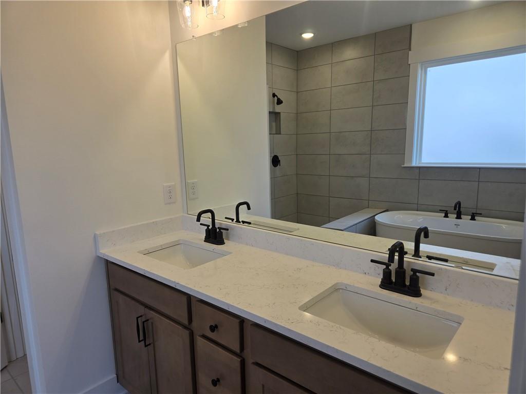 215 Coffee Lane Hoschton, GA 30548 - Photo 8 of 34 a bathroom with a sink and a mirror