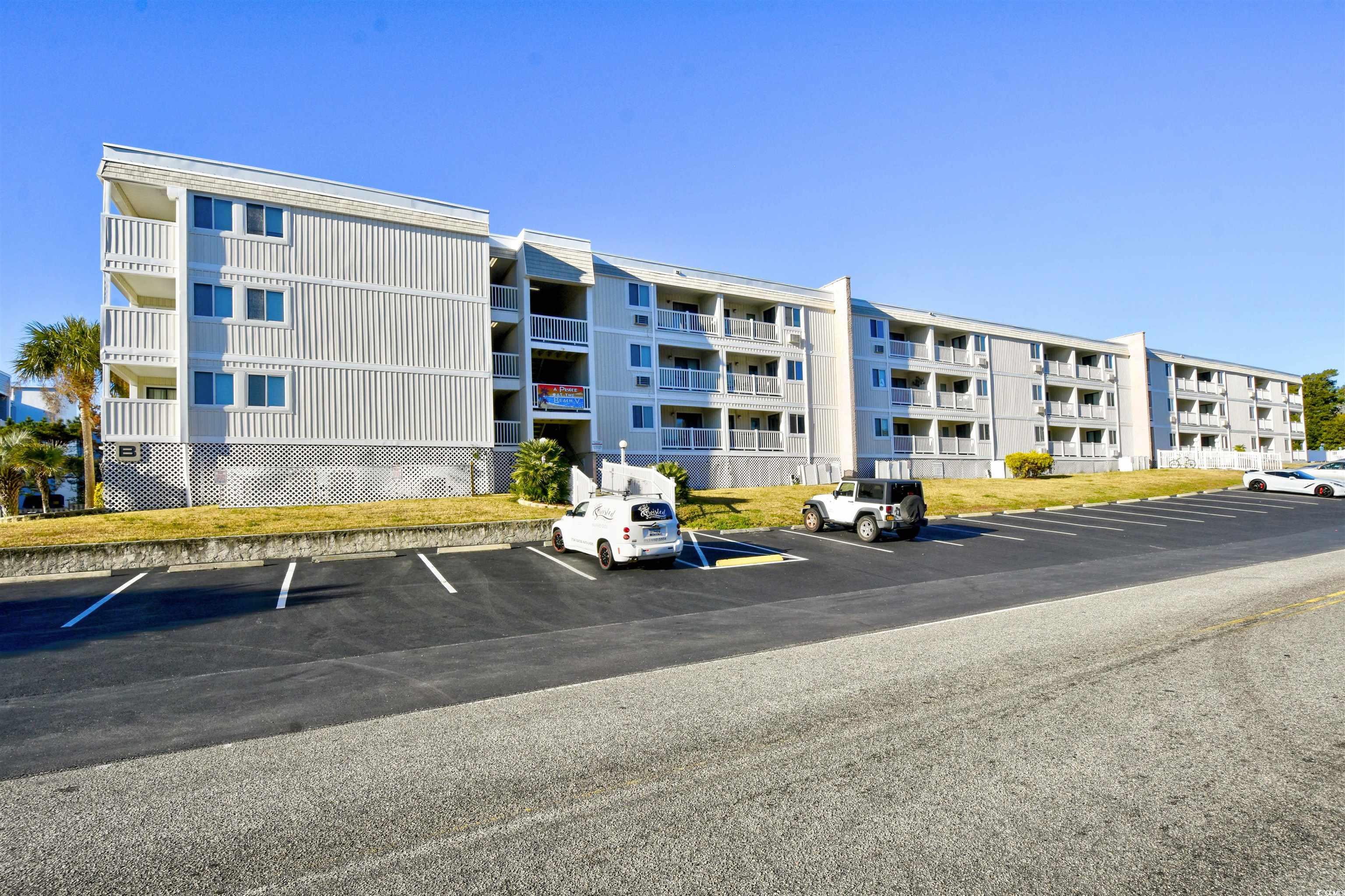 191 Maison Drive, Unit B211 Myrtle Beach, SC 29572 - Photo 1 of 35 View of apartment building / complex featuring uncovered parking