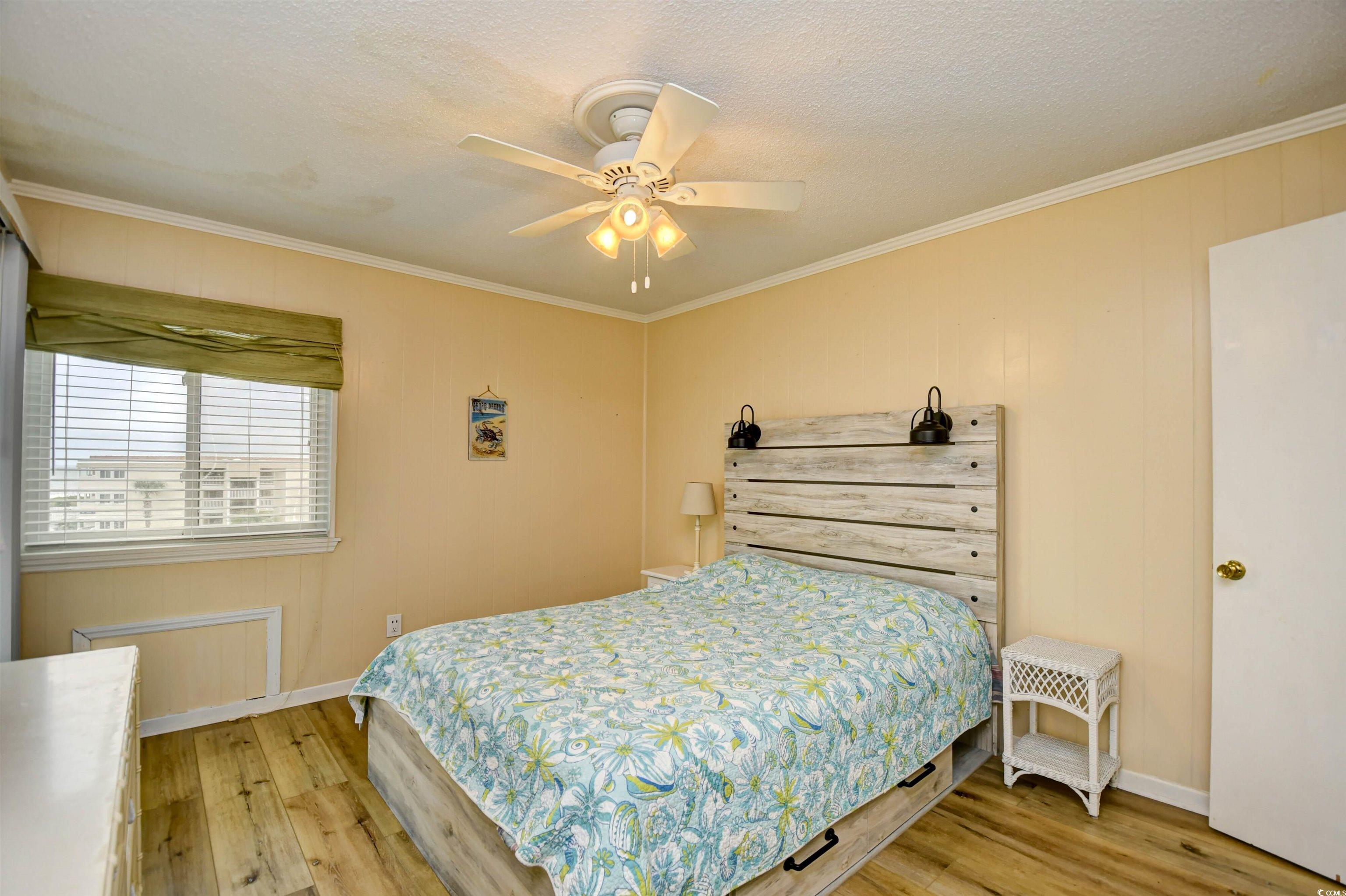 191 Maison Drive, Unit B211 Myrtle Beach, SC 29572 - Photo 12 of 35 Bedroom with ornamental molding, light wood-style flooring, ceiling fan, and a textured ceiling