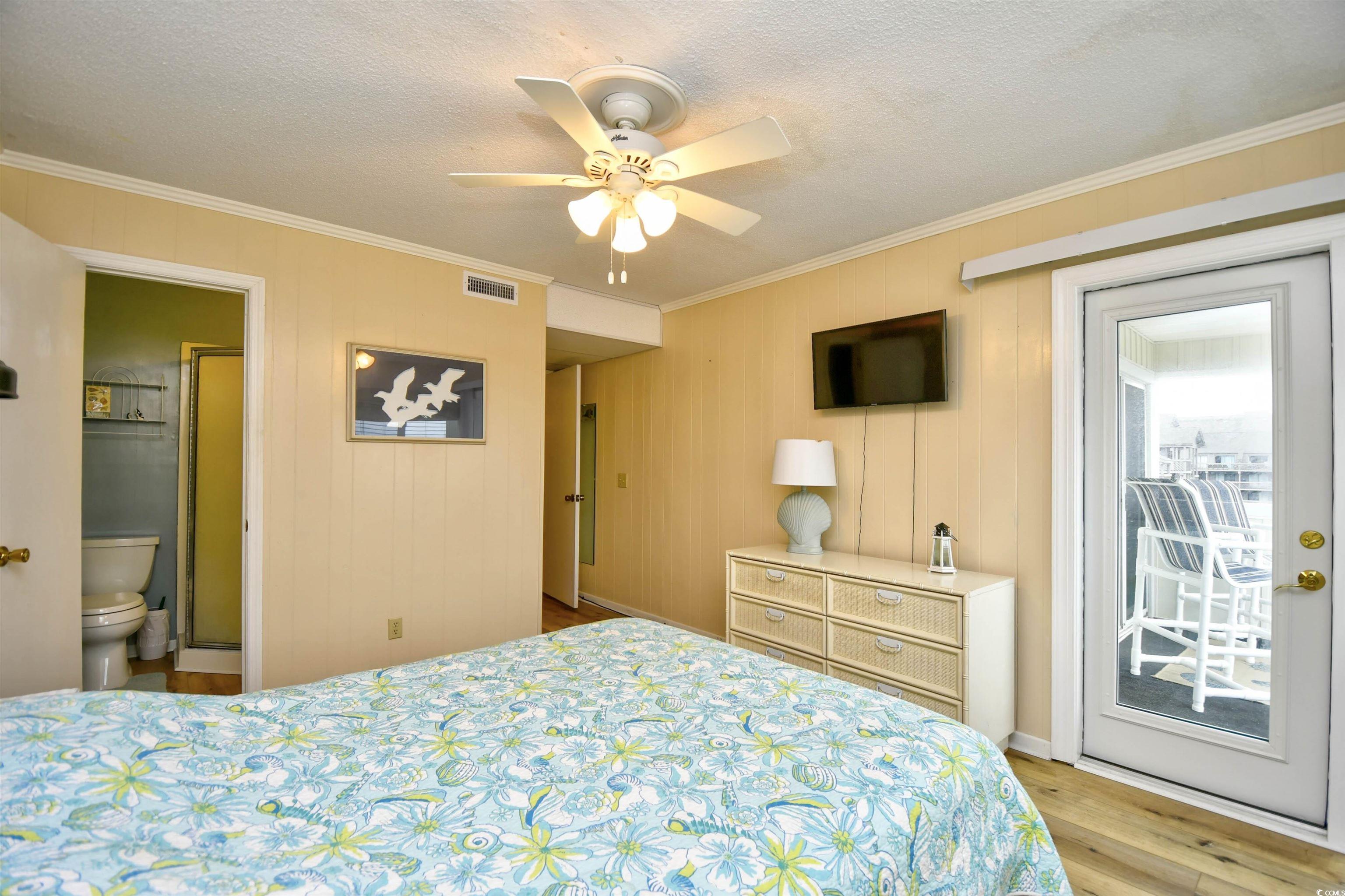 191 Maison Drive, Unit B211 Myrtle Beach, SC 29572 - Photo 14 of 35 Bedroom with crown molding, light wood finished floors, access to outside, ceiling fan, and a textured ceiling