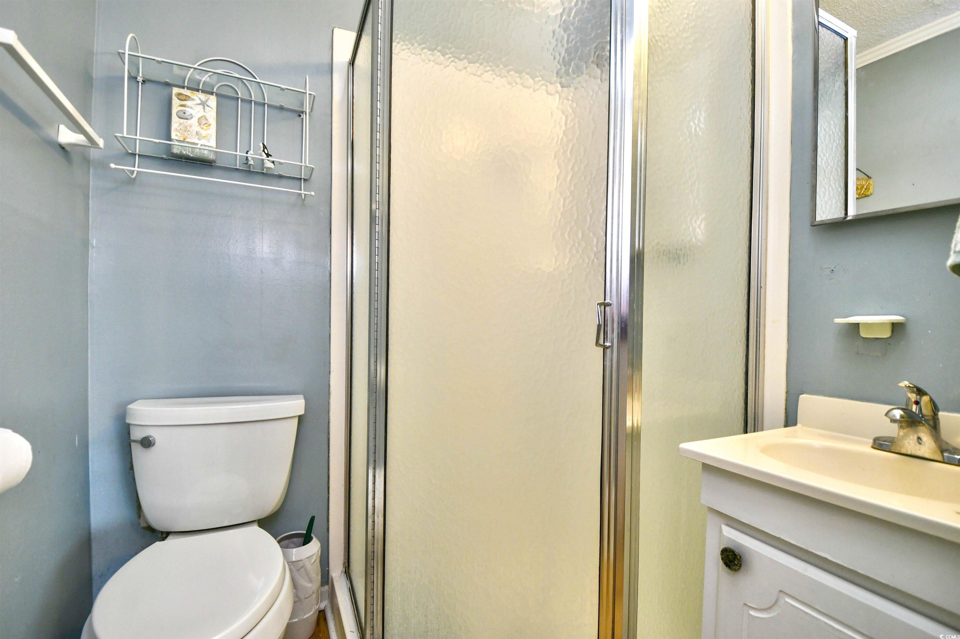 191 Maison Drive, Unit B211 Myrtle Beach, SC 29572 - Photo 16 of 35 Full bathroom with vanity, a stall shower, and crown molding