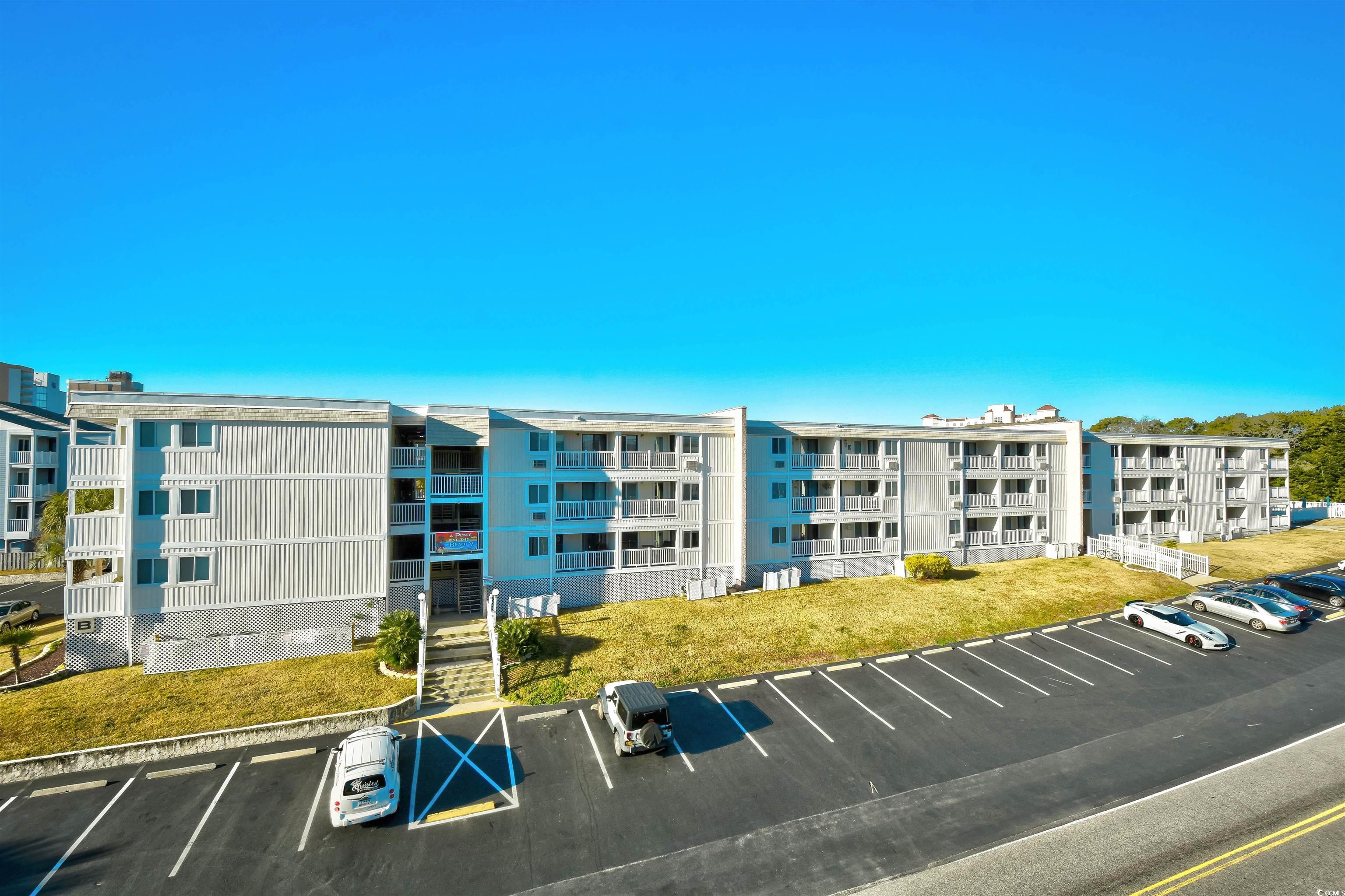 191 Maison Drive, Unit B211 Myrtle Beach, SC 29572 - Photo 31 of 35 View of apartment building / complex featuring uncovered parking