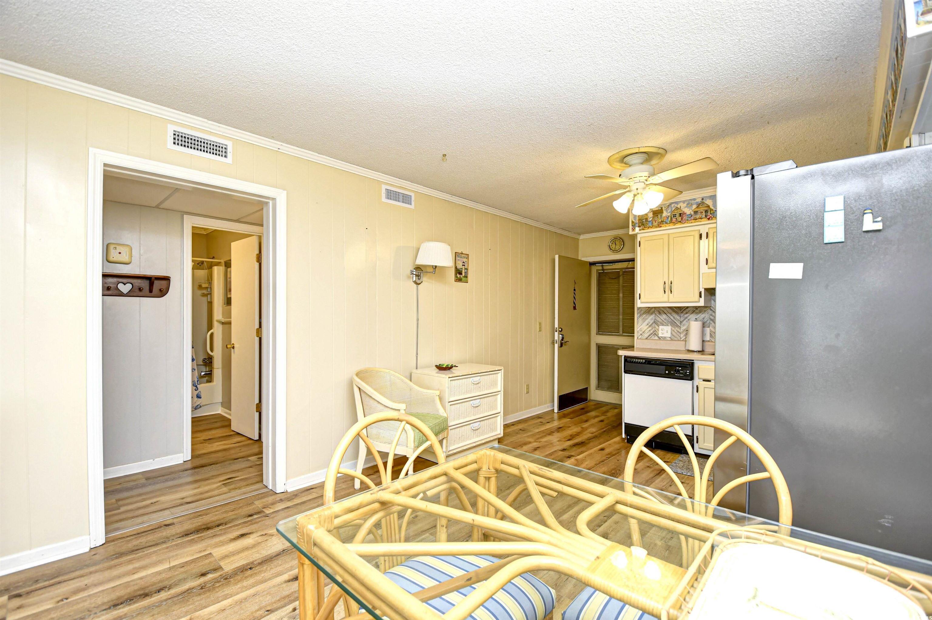 191 Maison Drive, Unit B211 Myrtle Beach, SC 29572 - Photo 8 of 35 Dining space with ornamental molding, light wood-style floors, a textured ceiling, and a ceiling fan