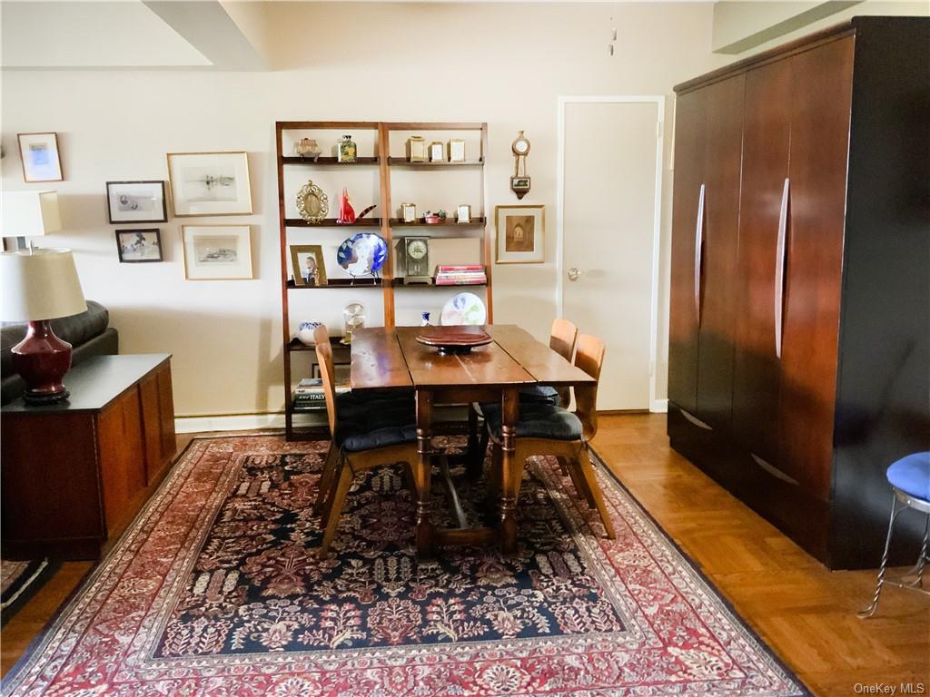 a dining room with furniture and rug