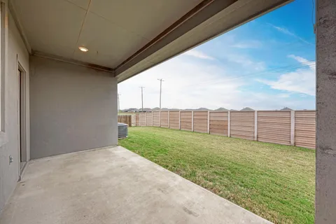 a view of a backyard with fence
