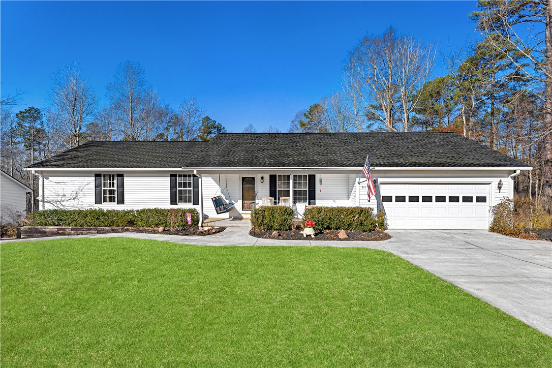 281 Cherokee Drive Fair Play, SC 29643 - Photo 20 of 26 This charming home offers a perfect blend of comfort and natural beauty, featuring a well-maintained lawn.